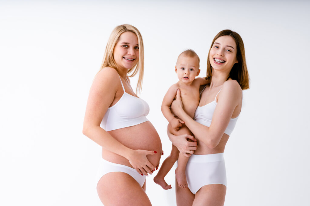 pregnant mom and a mom with her baby